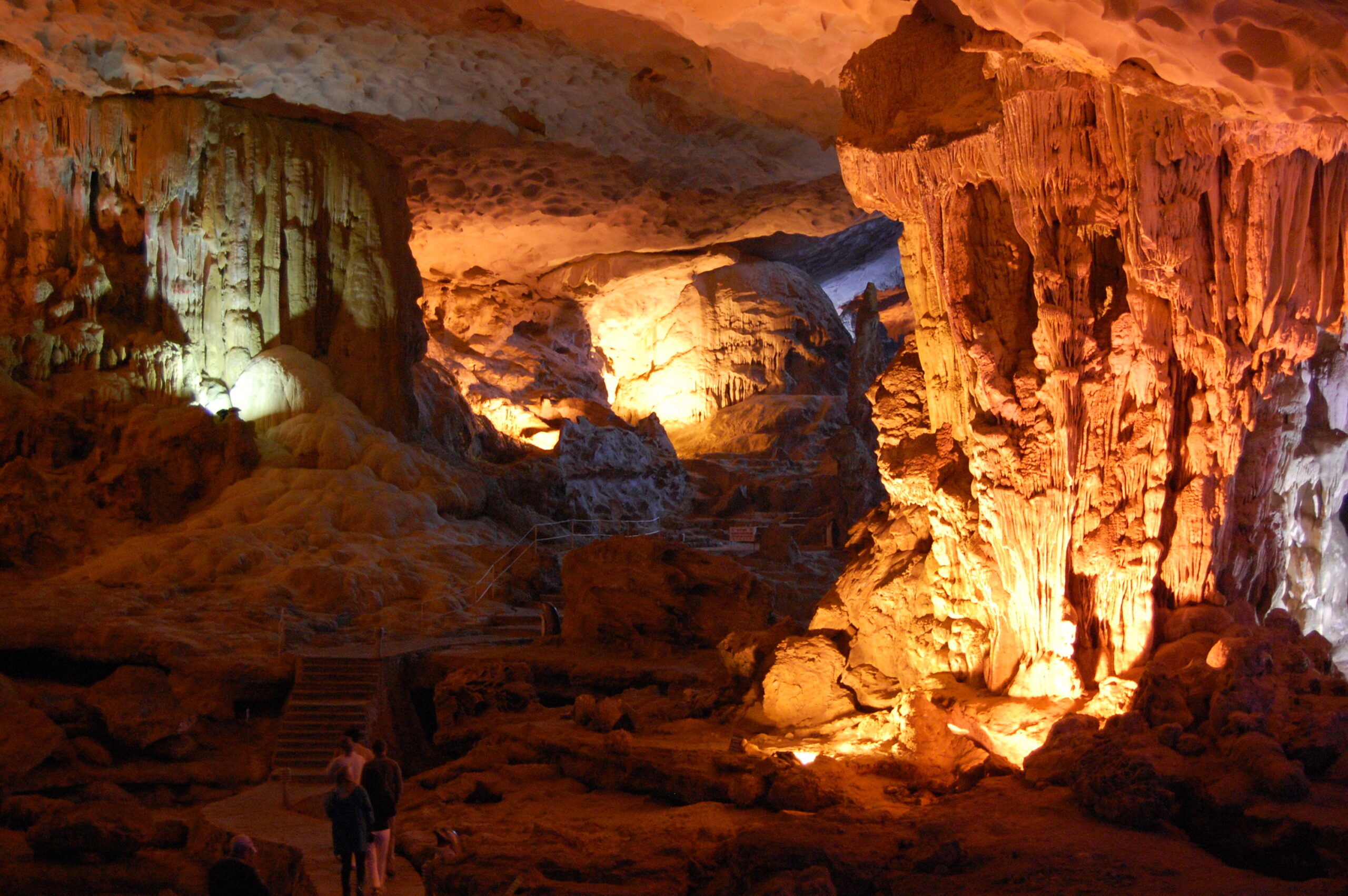 Ha Long Bay cave interior Hang Sung Sot Surprise Cave stalactites stalagmites dramatic lighting Vietnam