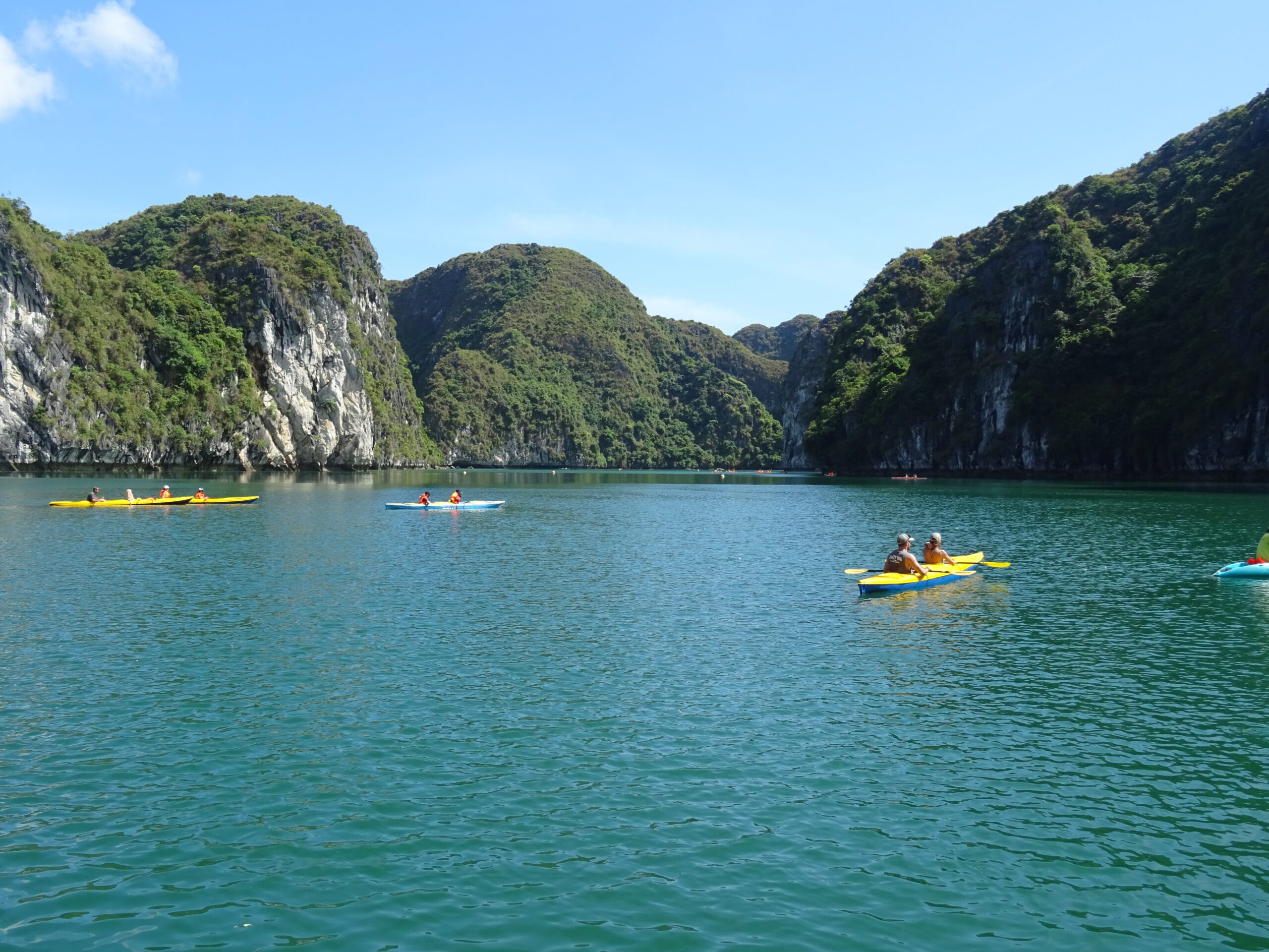 Kayaking Ha Long Bay Vietnam hidden lagoon sea cave emerald water limestone arch